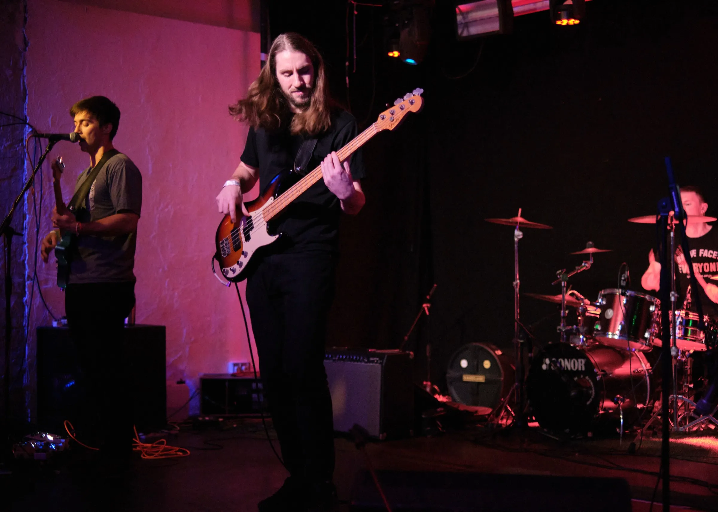 Jamie playing bass live on stage